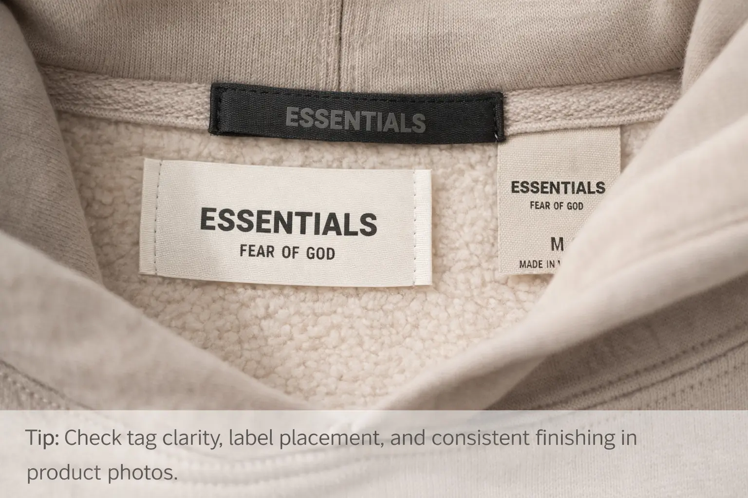 Close-up of Fear of God Essentials hoodie label and tag details for authenticity checks